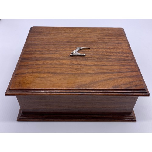 73 - An oak box, the rectangular lid with applied silver crest, the interior divided, platform base with ... 