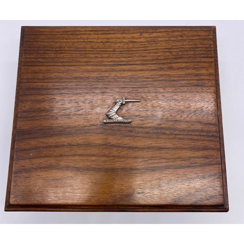 73 - An oak box, the rectangular lid with applied silver crest, the interior divided, platform base with ... 