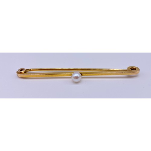 8 - Gold pin brooch onset small pearl, stamped M&M 9c Length: 55mm 
Together with an Edwardian peridot a... 