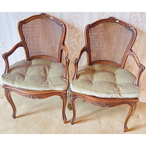 203 - French style walnut chairs, the shaped top rails above Bergere back and open scroll arms, raised on ... 