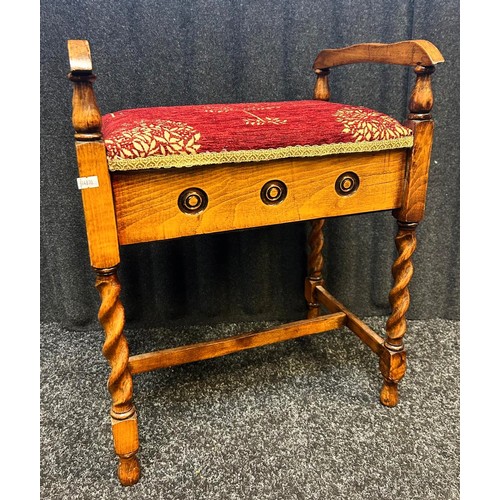 224 - A reproduction Piano stool with lift up seat raised on barley twist legs.