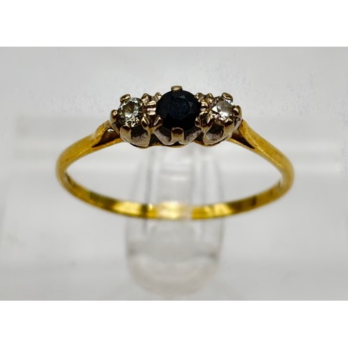 26 - 18ct gold ladies three stone ring, two outer diamonds and black sapphire to the centre 
Weight - 2.2... 