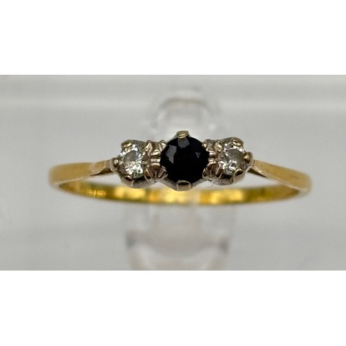 26 - 18ct gold ladies three stone ring, two outer diamonds and black sapphire to the centre 
Weight - 2.2... 