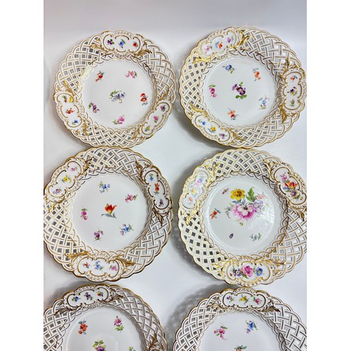 63 - Set of 9 Meissen porcelain dishes with openwork rims, the central roundel decorated with spaced flow... 