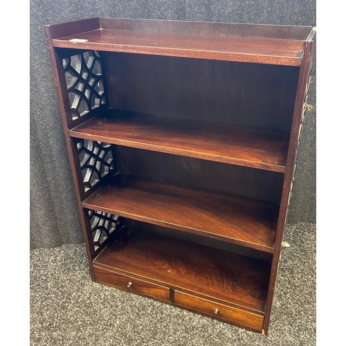 325 - A reproduction dark wood open shelved wall unit, with two short drawers and pierced ends. [83x61x21.... 