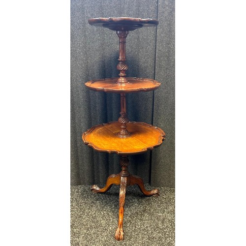 234 - A reproduction three tier mahogany dumb-waiter with pie crust edging raised on tripod base ending in... 