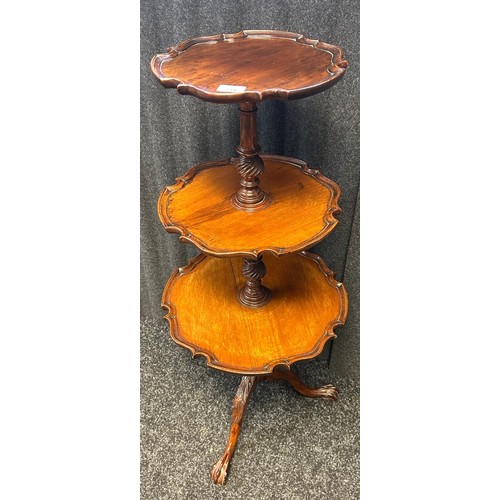 234 - A reproduction three tier mahogany dumb-waiter with pie crust edging raised on tripod base ending in... 