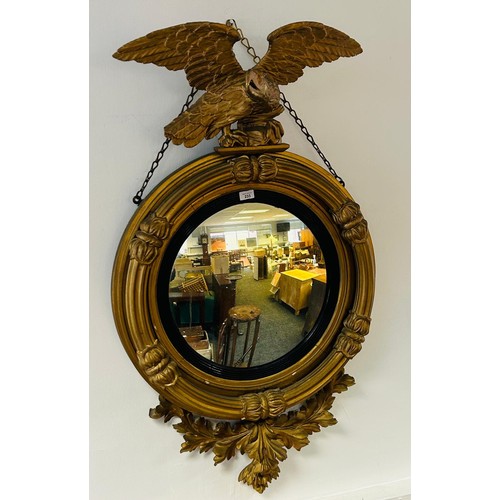 233 - Regency giltwood mirror, the circular convex mirror within a reeded join, surmounted by an eagle, th... 