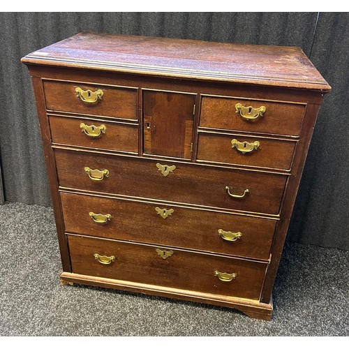 222 - A late 18th century oak chest off drawers, the rounded rectangular moulded top above a central small... 