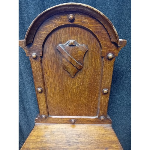 243 - Two 19th Century Oak Carved Hall Chairs with shield and foliate designs