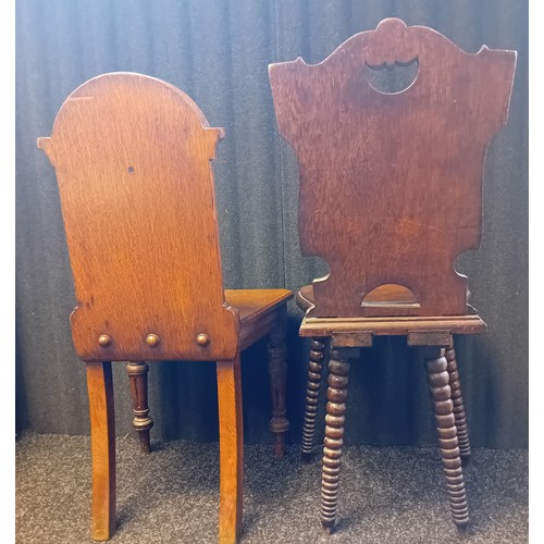 243 - Two 19th Century Oak Carved Hall Chairs with shield and foliate designs