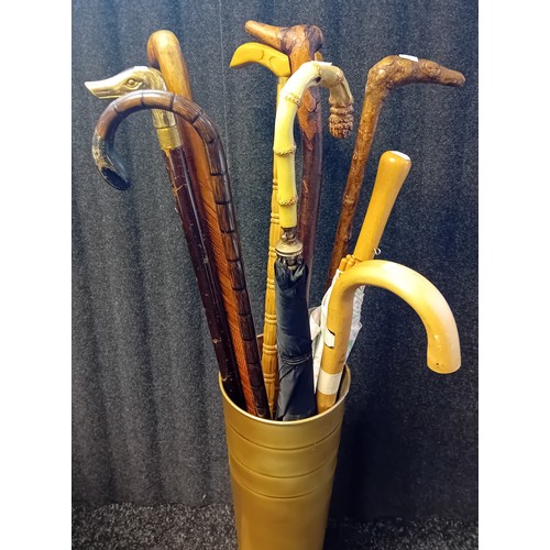 421 - Gold Tin Stick Stand filled with various walking sticks and umbrellas