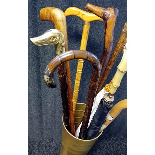 421 - Gold Tin Stick Stand filled with various walking sticks and umbrellas