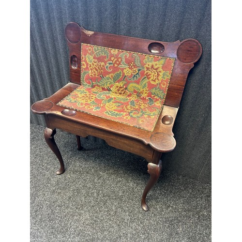 302 - A 19th century mahogany flip top table the shaped surface opening to centre surface with needle work... 