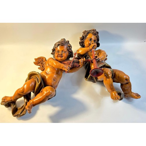 91 - A pair of painted carved wood putto
Each playing an instrument