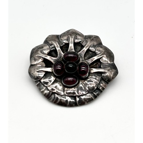 1 - Georg Jensen - A rare silver and cabochon garnet set brooch, no 64, 836, as a stylised flower head, ... 