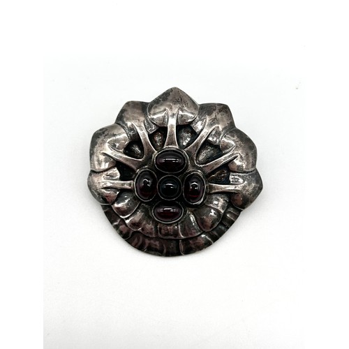 1 - Georg Jensen - A rare silver and cabochon garnet set brooch, no 64, 836, as a stylised flower head, ... 