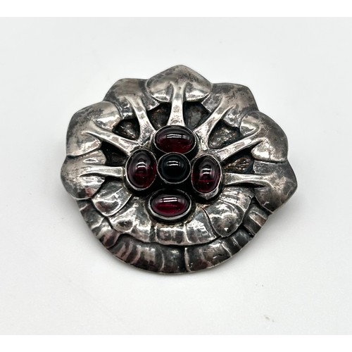 1 - Georg Jensen - A rare silver and cabochon garnet set brooch, no 64, 836, as a stylised flower head, ... 