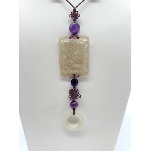 4 - A Chinese jade and amethyst bead long necklace, principal pierced rectangular panel , silk cord with... 