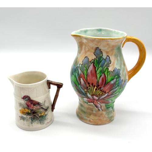 395 - Royal Worcester - a small jug decorated with a Chaffinch on white staved body, branch form handle, g... 