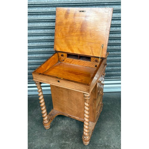 291 - 19th Century Maple davenport, the sloped leather surface opening to storage, flanked by banks of dra... 