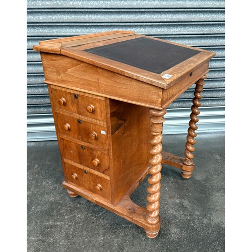 291 - 19th Century Maple davenport, the sloped leather surface opening to storage, flanked by banks of dra... 