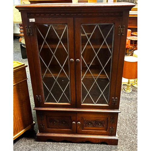 265 - A contemporary stained wood display case, the glazed doors opening to shelved interior above two cup... 