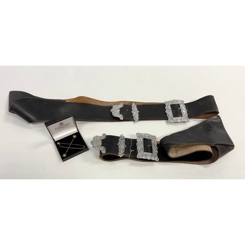 125 - Two pipers cross belts made from leather together with two pins