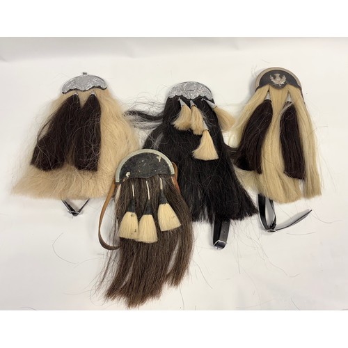 123 - Group of four large horse hair sporrans