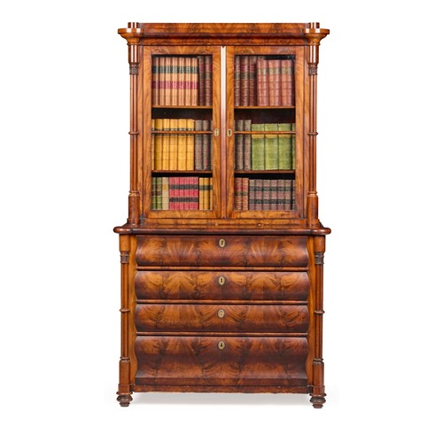 422 - Danish Mahogany bookcase on chest, the upper part with a pair of glazed doors enclosing shelves flan... 