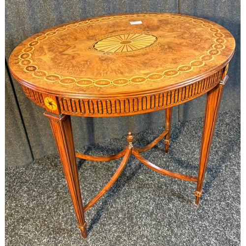 424 - A reproduction Burr walnut oval window table with parquetry design raised on squared tapered legs jo... 