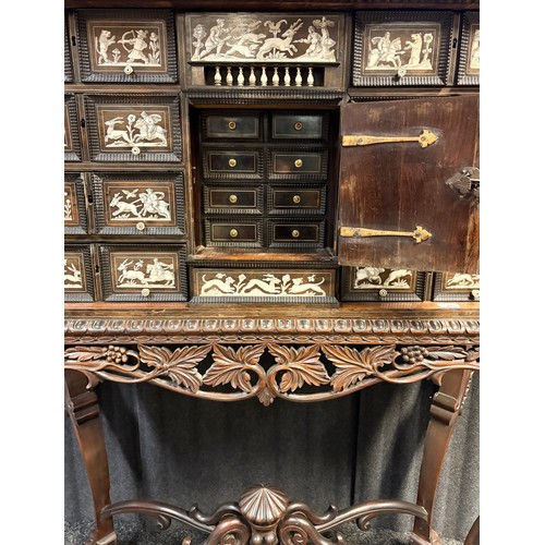 423 - 17th century, Rosewood cabinet on later stand, of eight drawers & cupboards enclosing small drawers ... 
