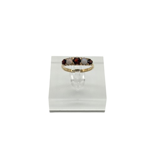 47 - 9ct Yellow Gold with round-cut Garnets and opal stones. 
Size - N
Weight - 2.42g