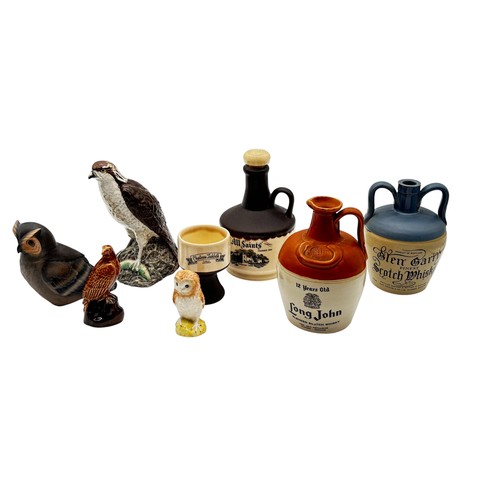 395 - Collection of whisky decanters and flagons to include Beswick Owl