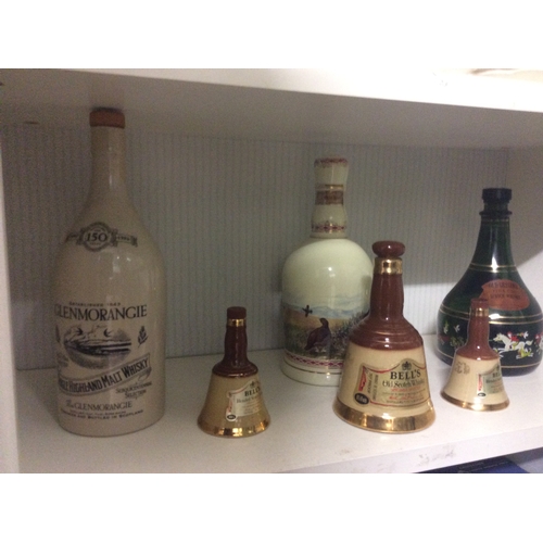 233 - Shelf of whisky decanters etc.