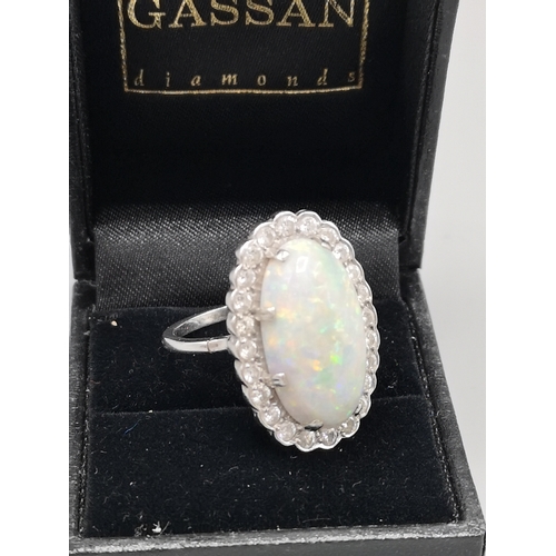 375 - Large white gold opal and diamond ring.
