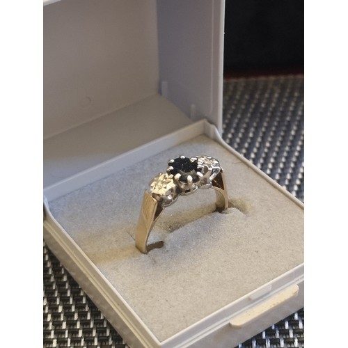 100e - 9ct gold 375 hall marked illusion cut diamond and blue stone ring possible sapphire.