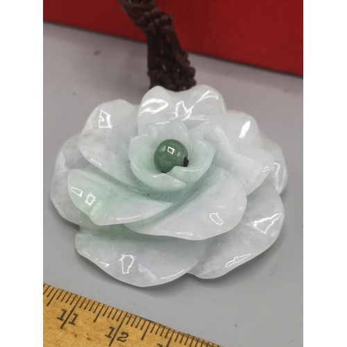 39a - Large jade flower pendant with eastern necklace.  60 grams gross weight with silk box.