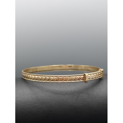 29 - 9ct rolled gold bangle with heart design. 8.81 grams gross weight .