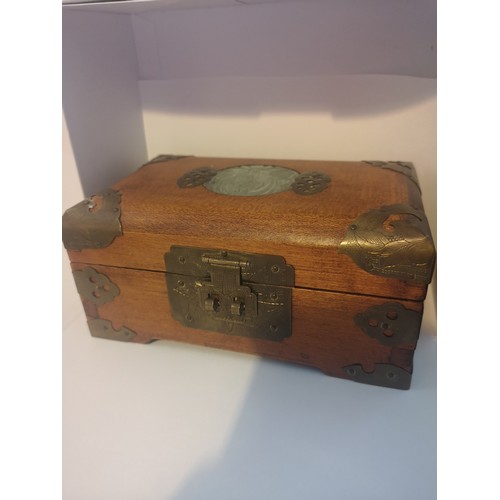 48 - Chinese carved box with brass bound with faux jade centre.