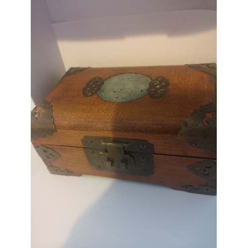 48 - Chinese carved box with brass bound with faux jade centre.
