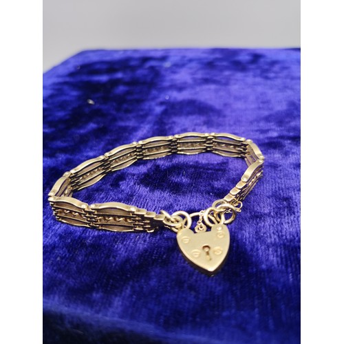4a - 9ct gold chunky heavy gate bracelet with 9ct padlock . 24.25 grams.