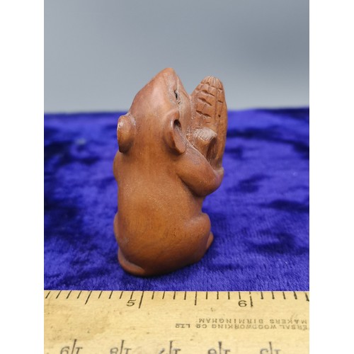 74 - Netsuke of mouse holding acorn.