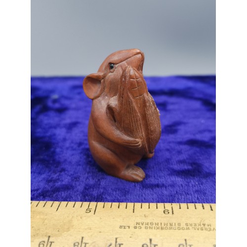 74 - Netsuke of mouse holding acorn.