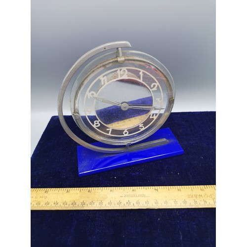 84 - Art deco mantle clock on blue plinth support.