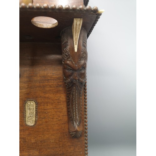 87 - Large black forest heavily carved pipe rack with inlays include s smoking pipes & 1900s bone cup.