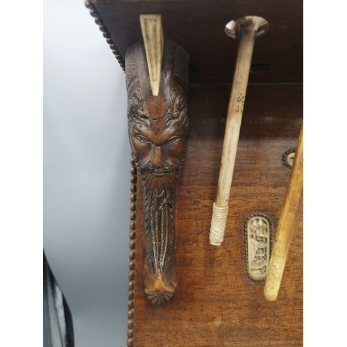 87 - Large black forest heavily carved pipe rack with inlays include s smoking pipes & 1900s bone cup.