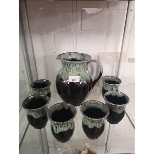 209 - Scottish studio pottery jug with 6 goblets.