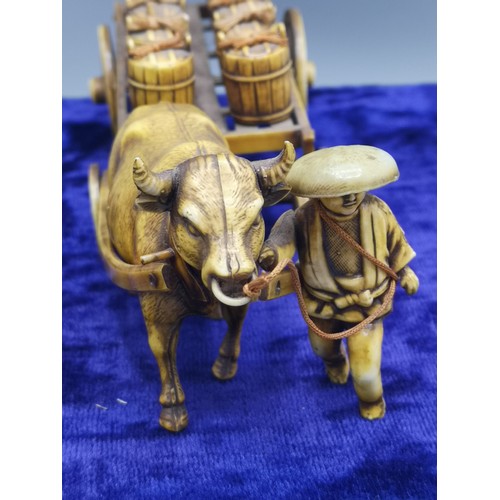 34 - Chinese figure display of farmer with transporting barrels.