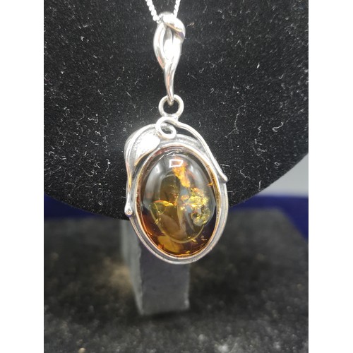 56a - Large silver pendant with Amber coloured stone possibly Amber together with silver chain.